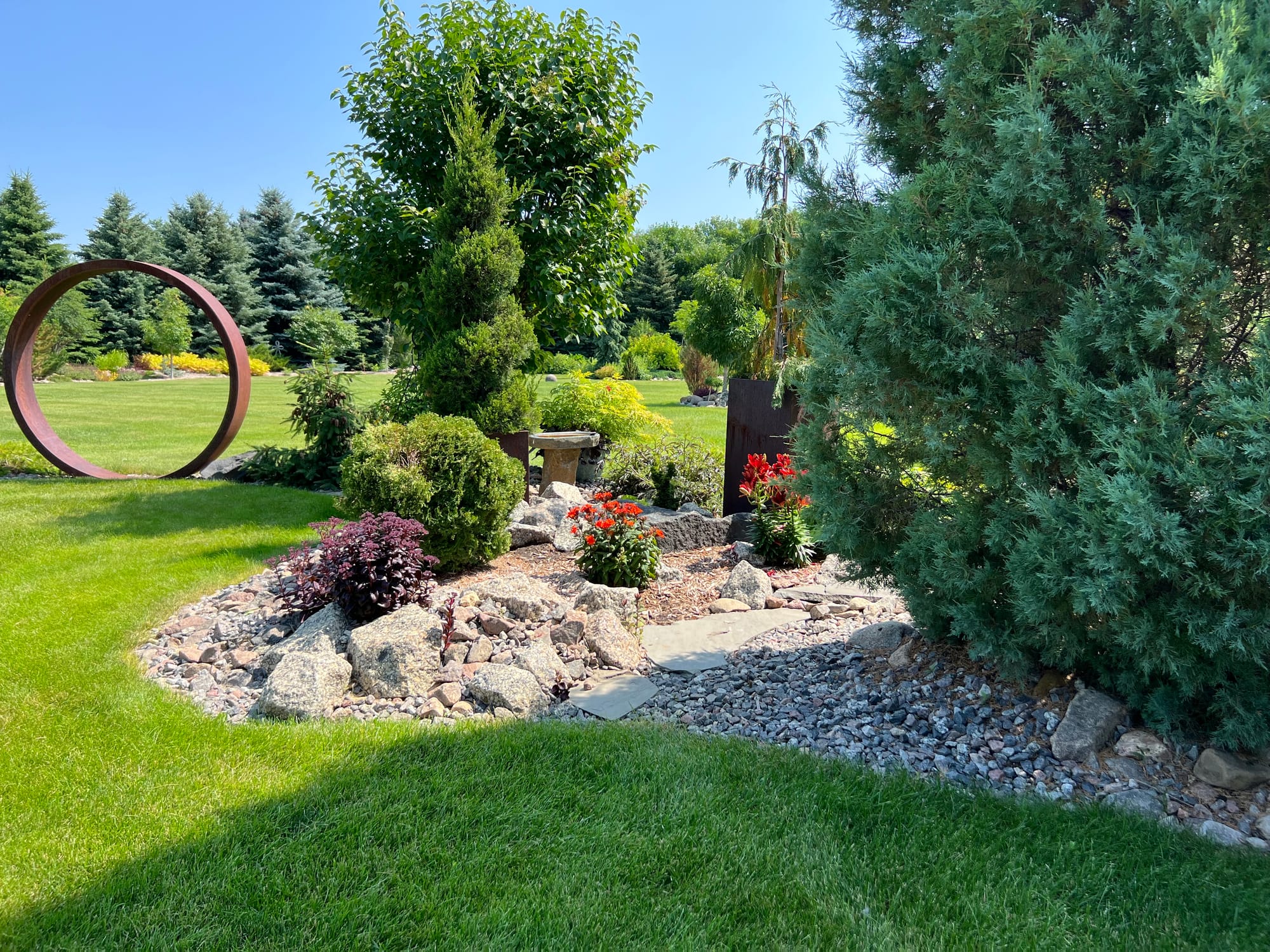 Landscape Bed With Plants, Pathway, And Rock